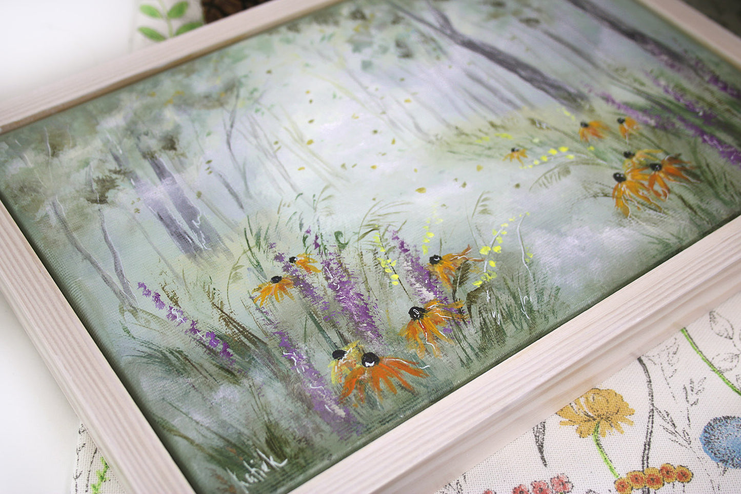 Hand-painted artwork of a misty autumn meadow with wildflowers