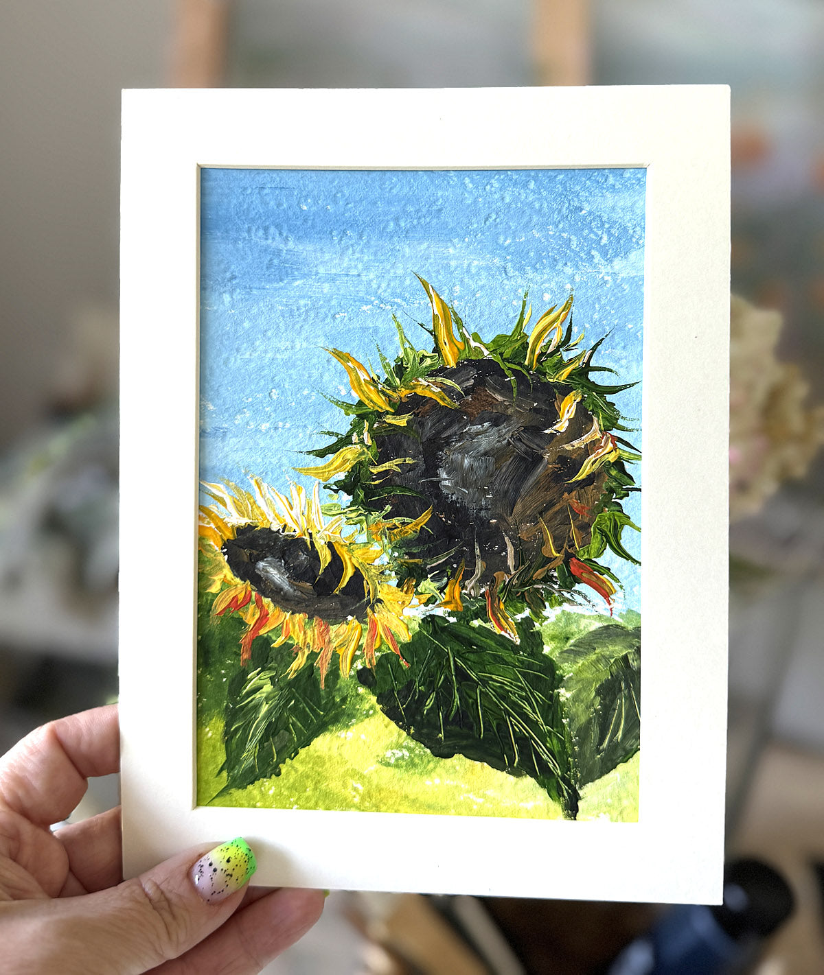 Framed artwork of sunflowers in expressive style