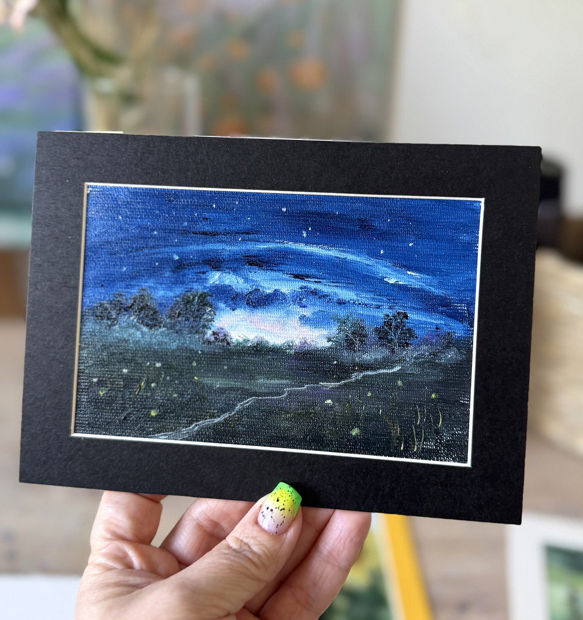 Miniature oil painting of a night meadow with fireflies under a starry blue sky, original artwork by Katie Koroleva.