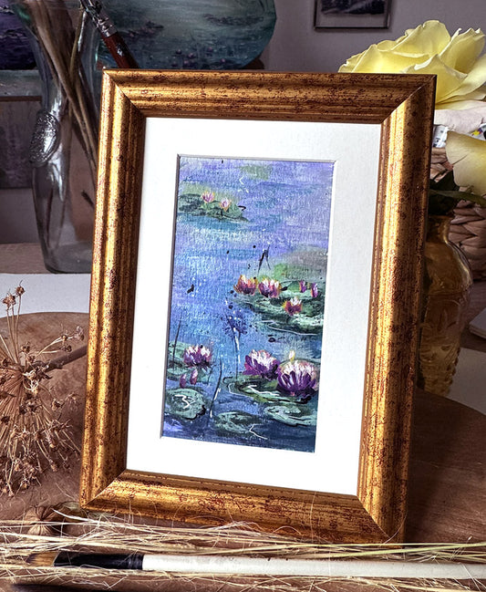 Framed artwork of water lilies in monet style