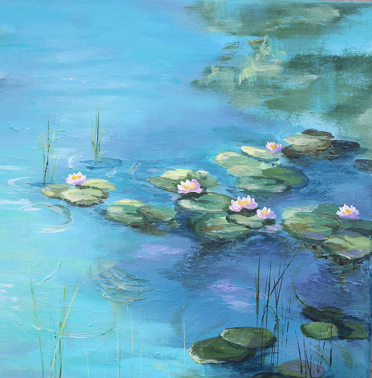 Painting of water lilies on a blue pond with green leaves