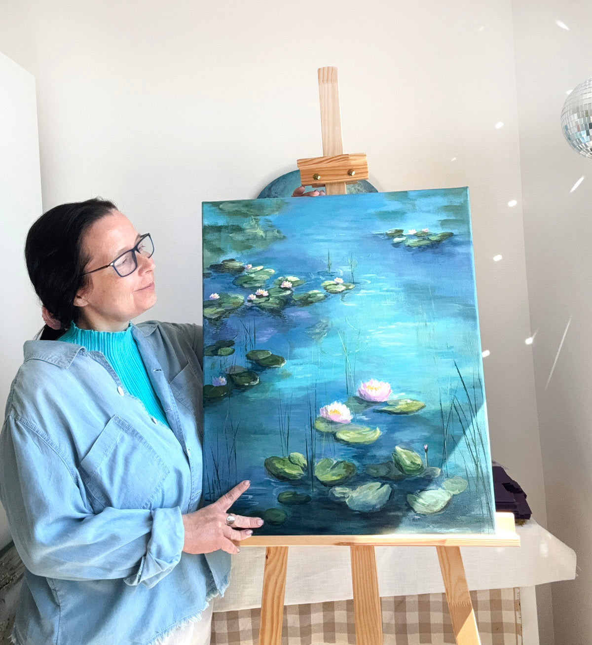 Painting of water lilies on a blue pond monet style