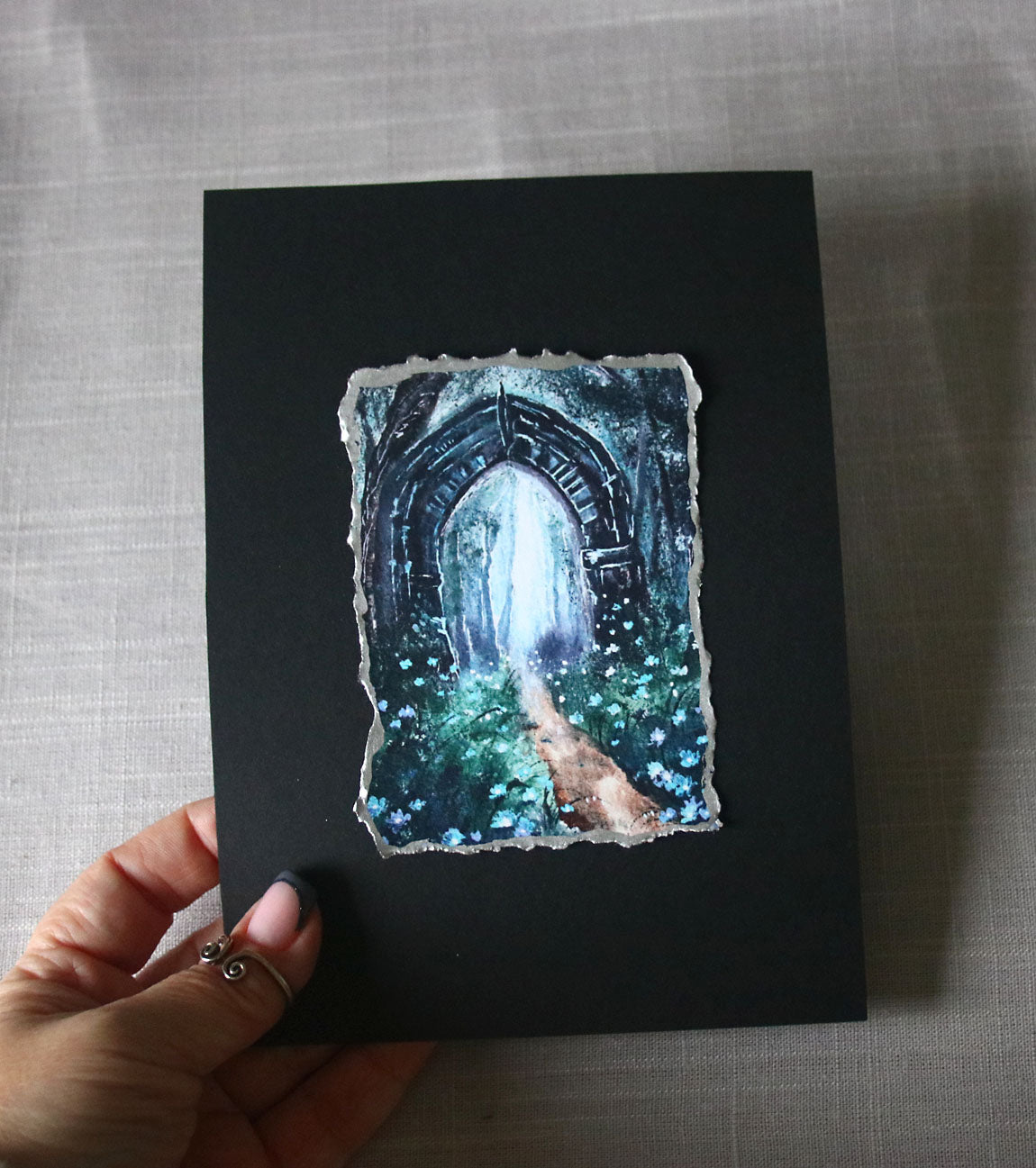 Gothic archway with a mystical landscape print