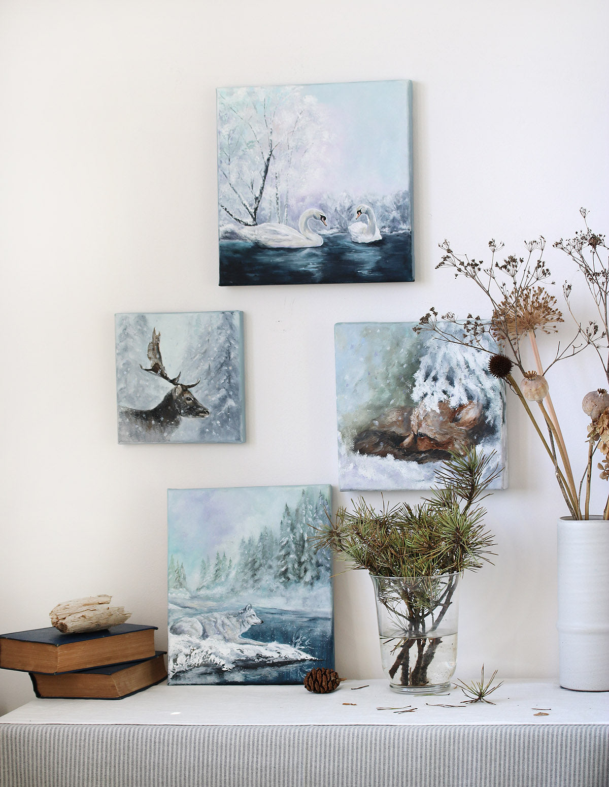 Set of nature-themed wall art pieces on a white wall with decorative elements.