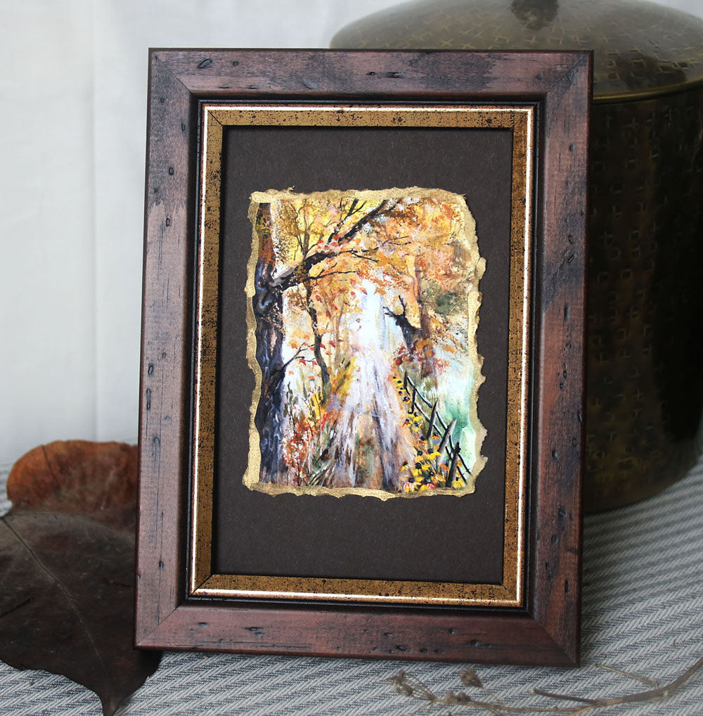 Framed artwork with a autumn themed landscape