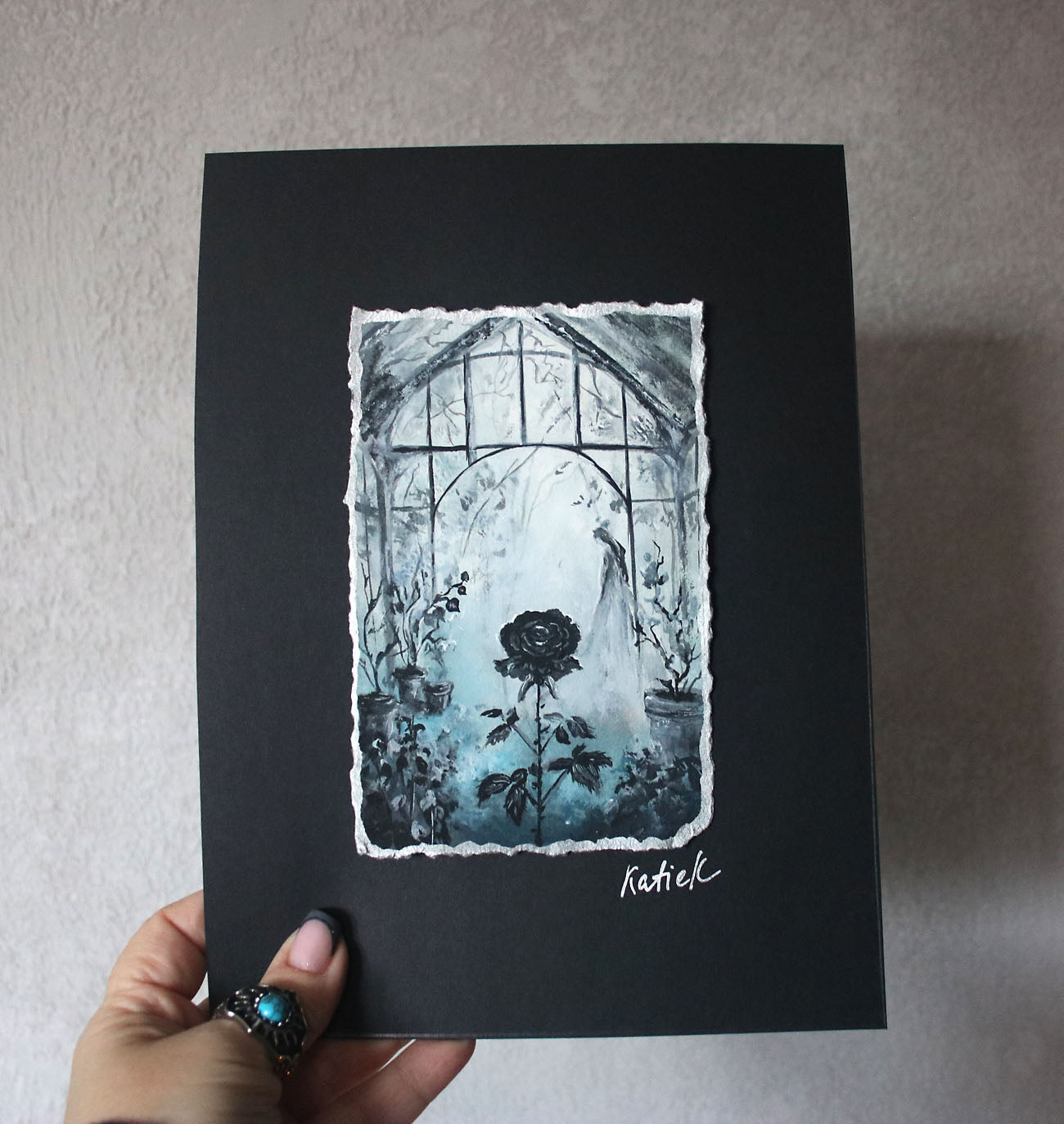 Artistic depiction of a black rose in front of a window on a black background