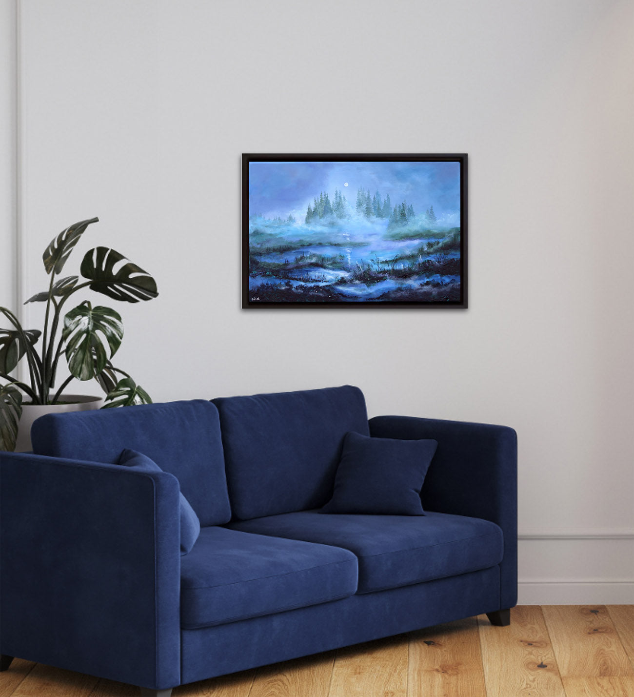 Blue sofa in a living room with a TV displaying a nature scene.