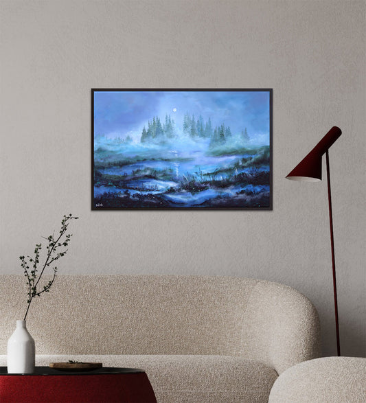 Framed artwork of a landscape with trees and water on a wall above a sofa.