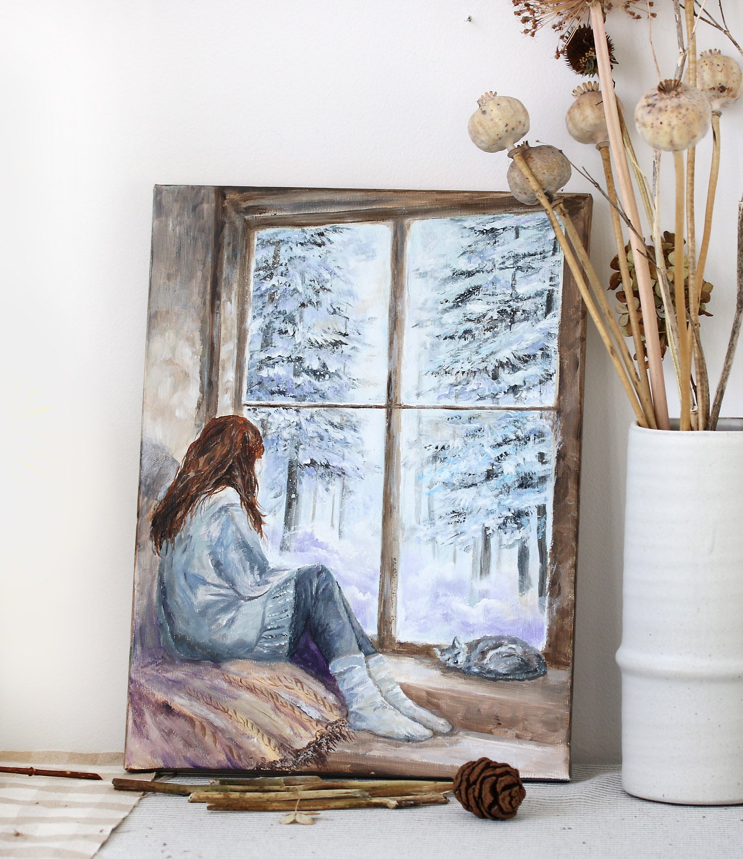 Cozy winter painting with a girl with a sleeping cat by the window