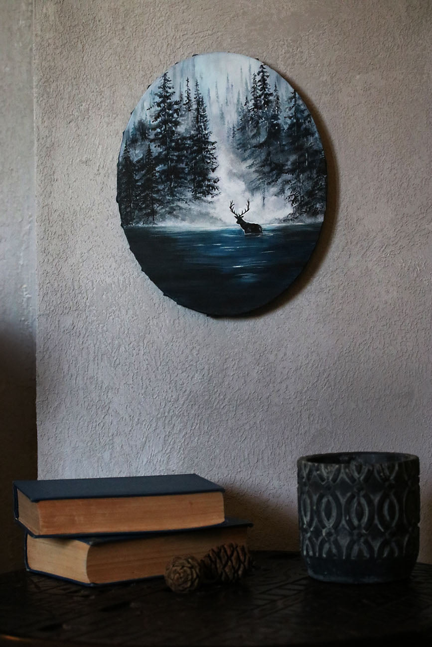 Mystical forest painting featuring a lone stag standing in misty teal water. Atmospheric woodland art with fog, depth, and a serene, enchanted mood.