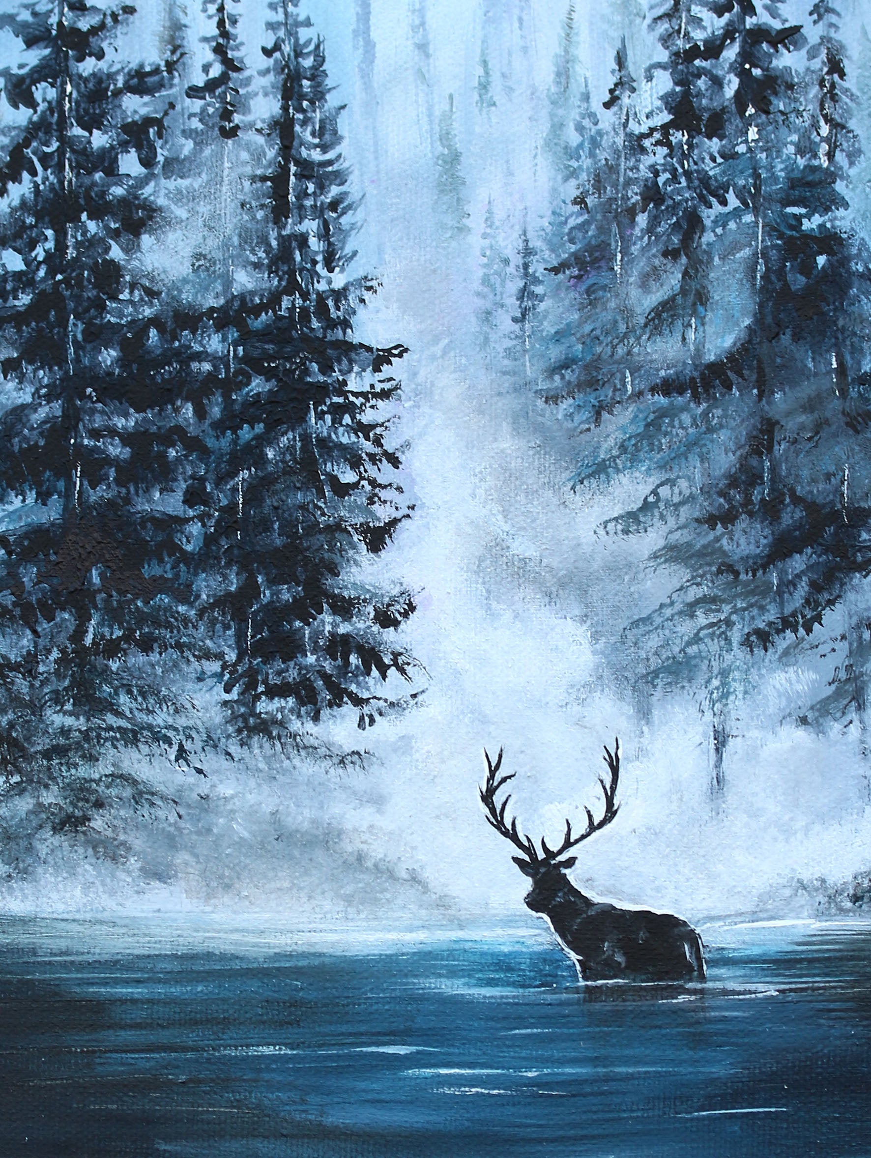 Deer in a forest with a waterfall