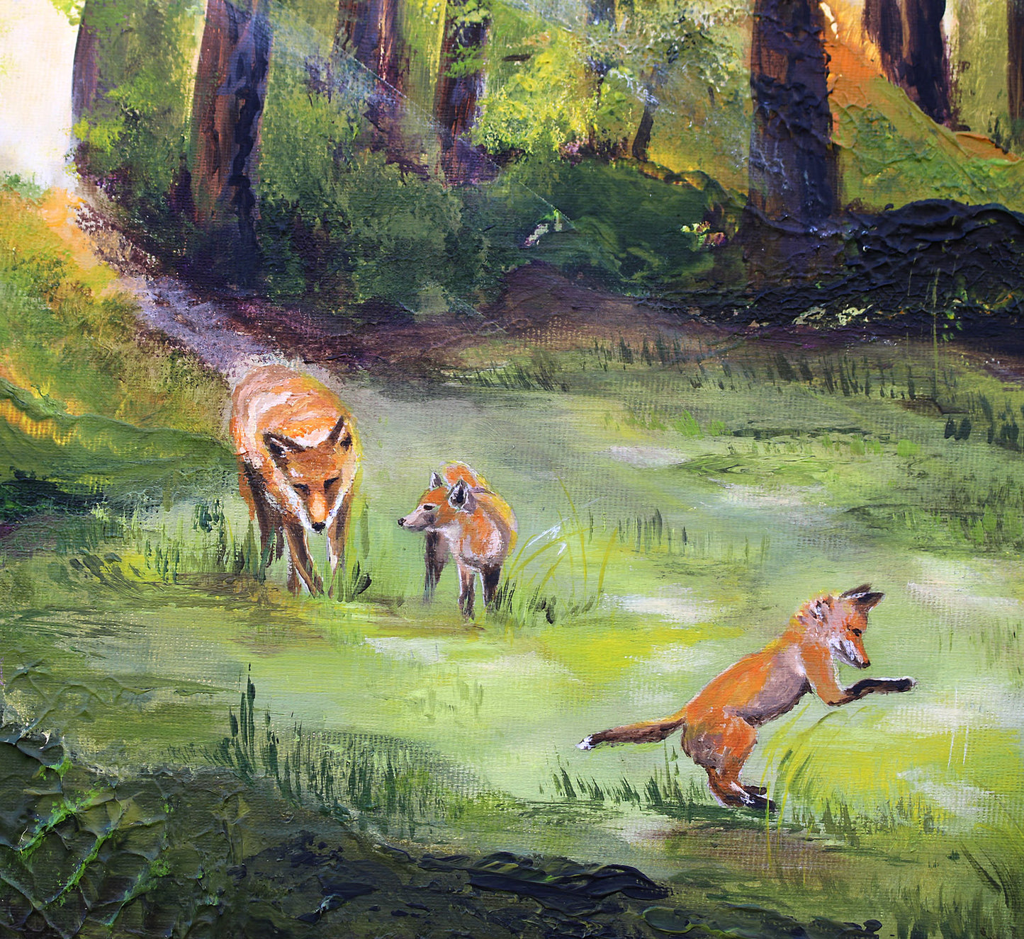 Impressionistic painting of three red foxes in a sunlit forest clearing, with one fox running across the foreground and two standing in the grass behind it among tall trees.