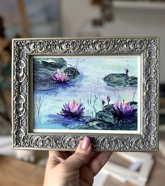 Framed artwork of water lilies painted in Monet style