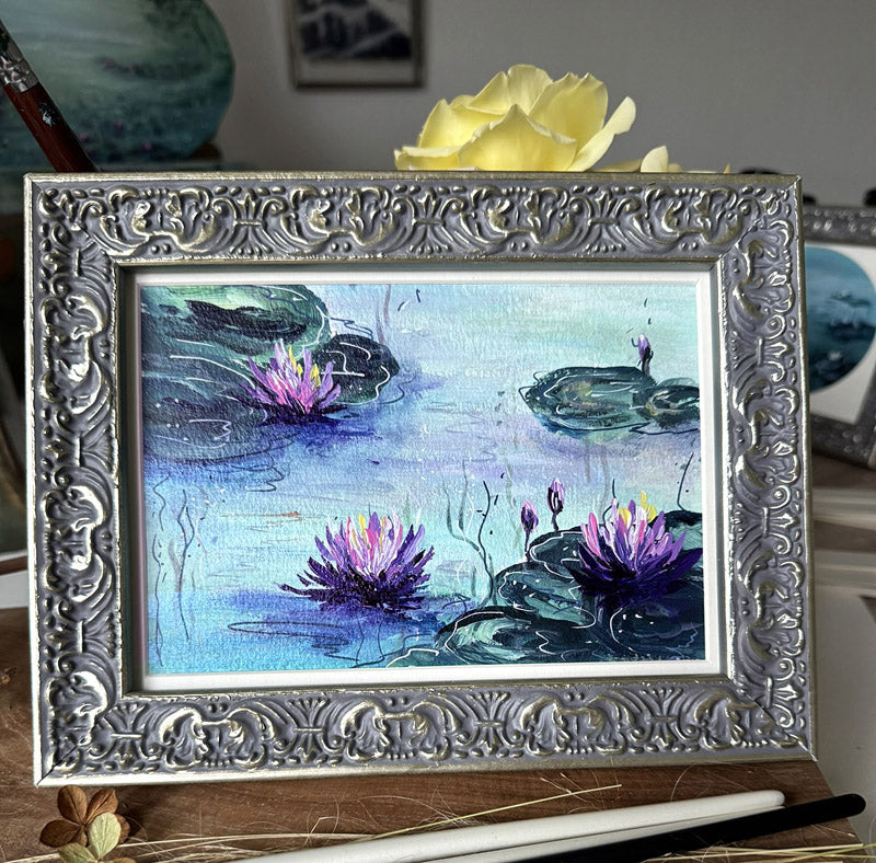 Framed painting of water lilies painted in impressionist style