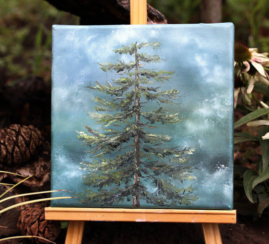 Painting of a tree on a canvas with a wooden easel, surrounded by natural elements.