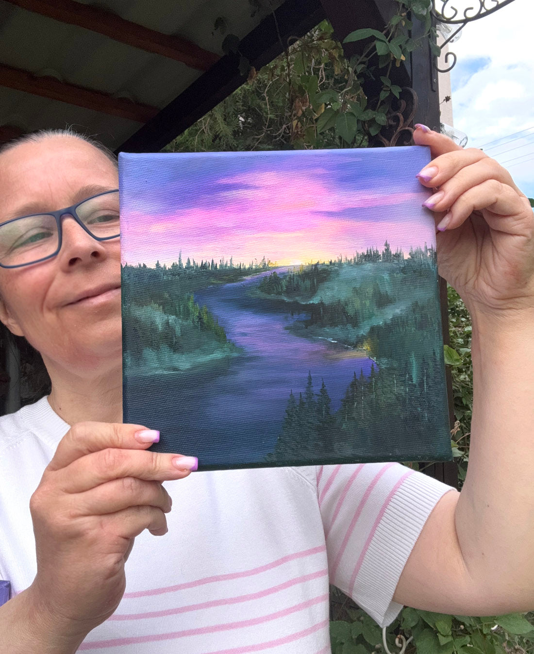 A landscape oil painting of a winding river or lake at sunset, with a purple and pink sky, dark evergreen trees, and misty hills along the banks.