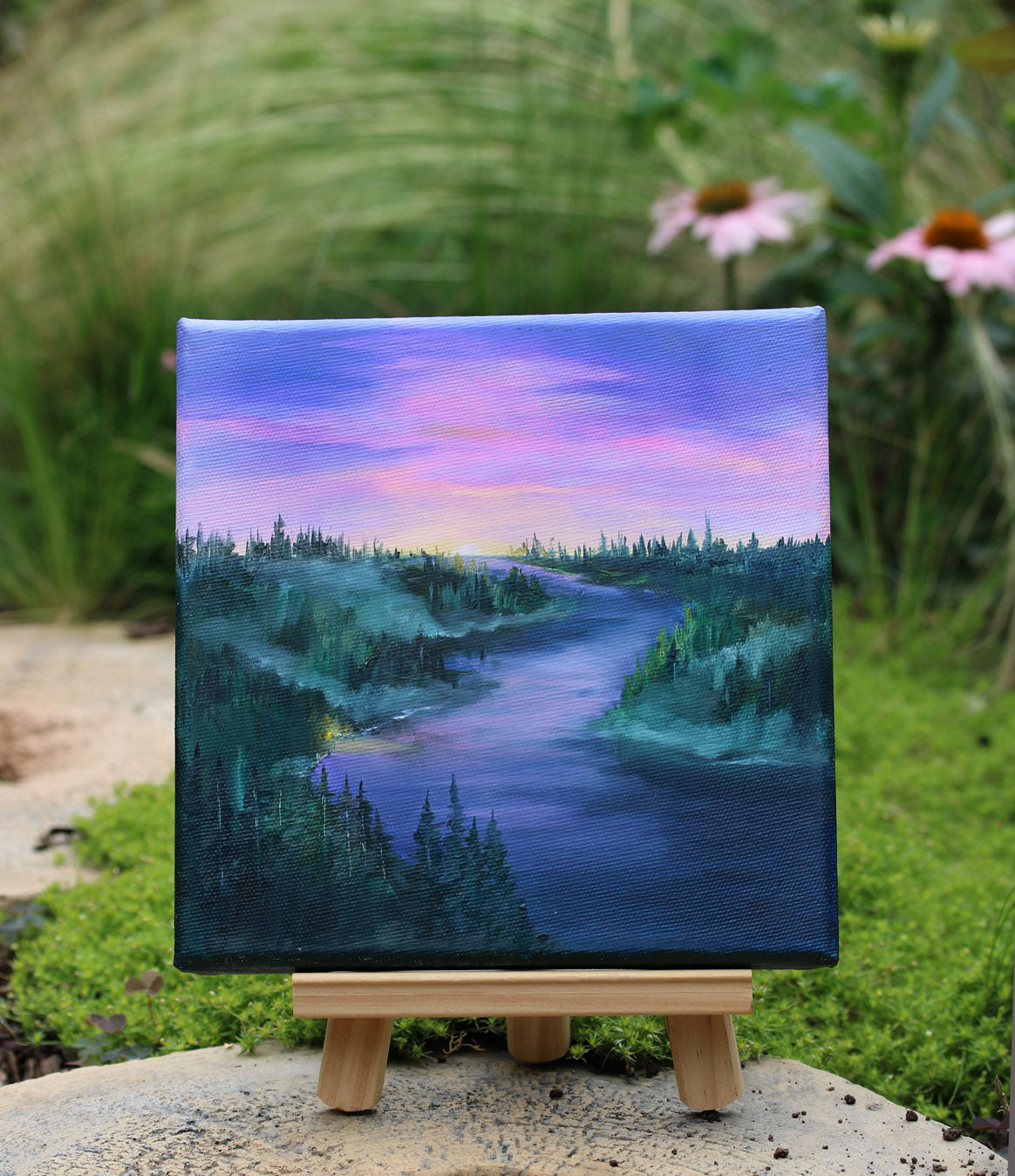 A landscape oil painting of a winding river or lake at sunset, with a purple and pink sky, dark evergreen trees, and misty hills along the banks.