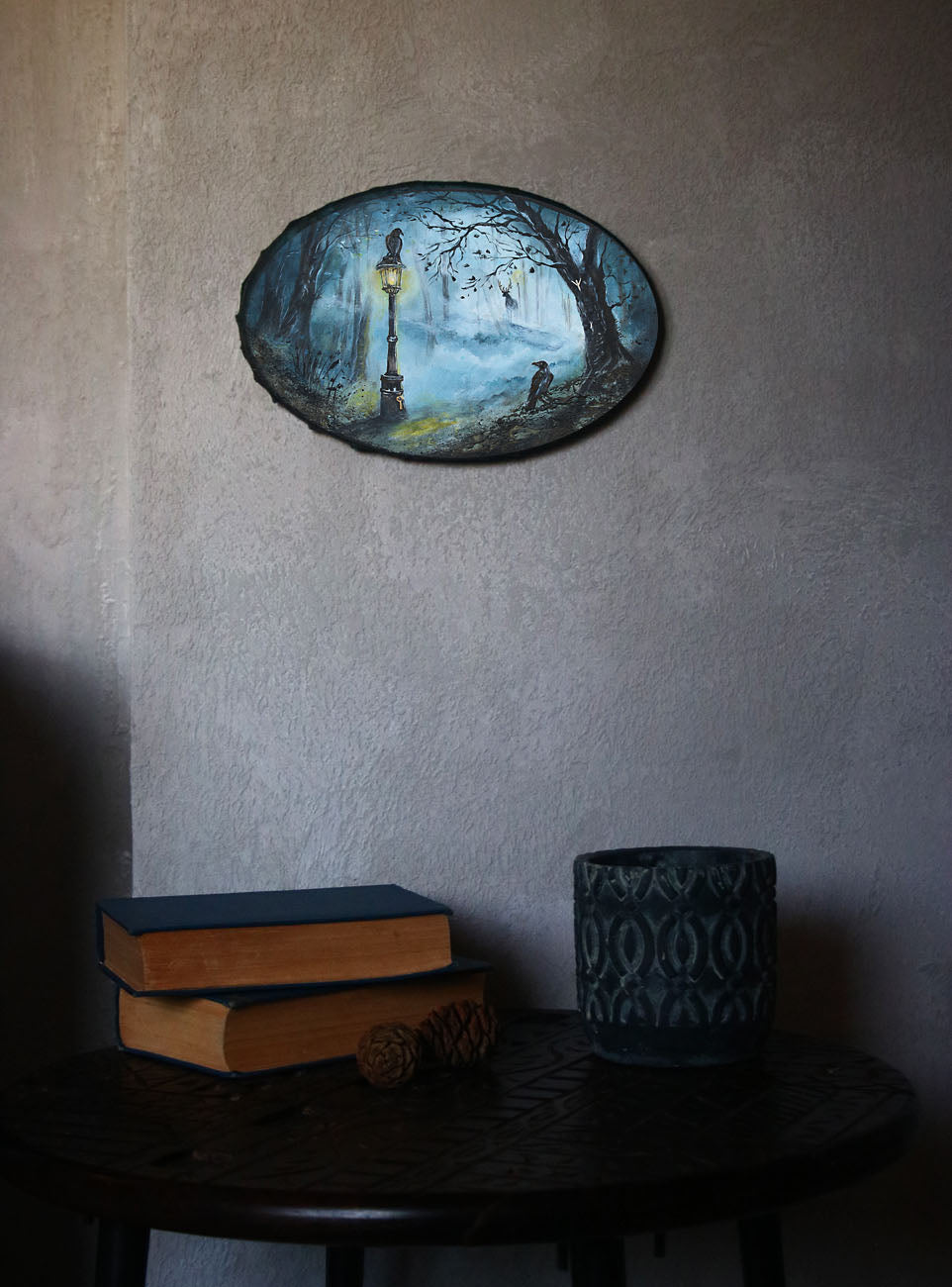 Mystical forest painting with glowing lantern, ravens, and soft teal mist. Enchanted woodland artwork featuring subtle runic symbolism and a moody, atmospheric path.