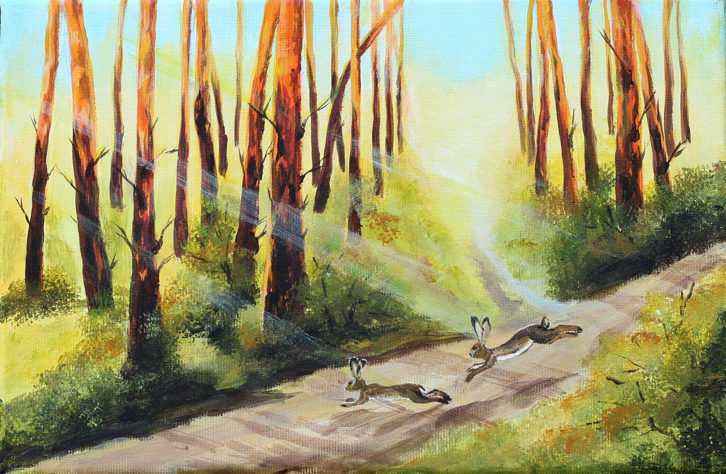 A painted forest scene with tall slender trees, a sunlit path, and three rabbits running across the foreground. The artwork fills the frame, so this is best classified as Scenery rather than Product/Packaging.