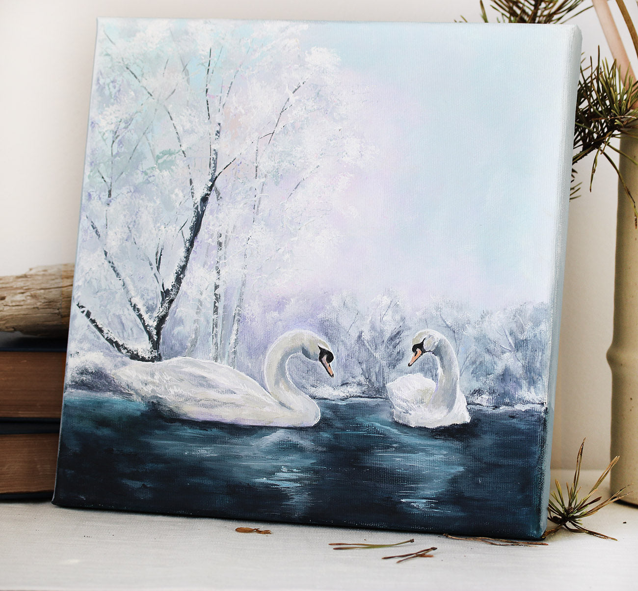Two swans on a frozen lake with snow-covered trees original painting