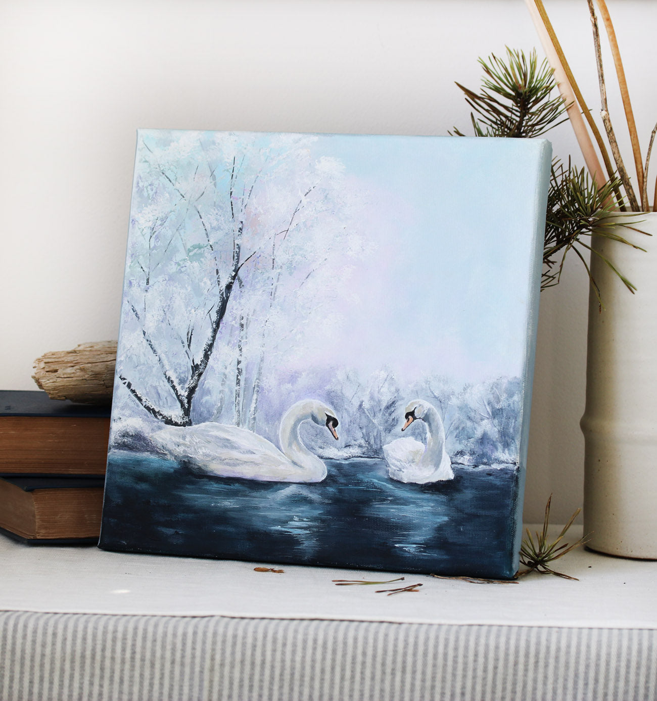 Two swans on a frozen lake with snow-covered trees original painting