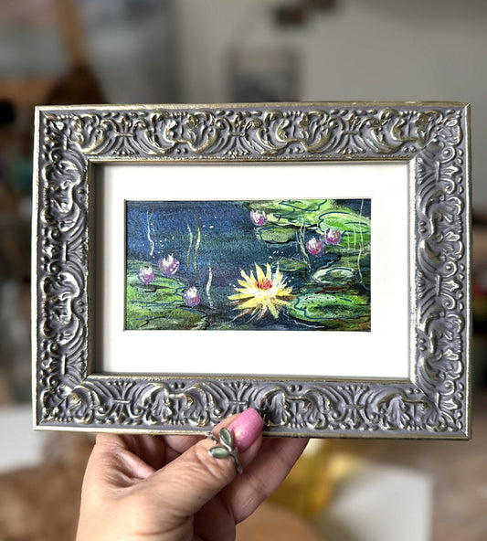 Framed artwork of water lilies Monet style painting